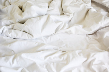 Obraz premium white pillow on bed and with wrinkle messy blanket in bedroom, f