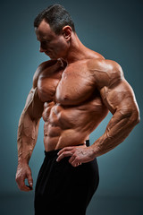 Fototapeta na wymiar torso of attractive male body builder on gray background.