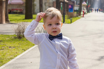 Boy in shirt is playing in park