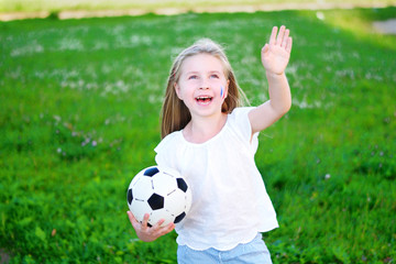 Naklejka premium Adorable little girl supporting her national football team during soccer championship