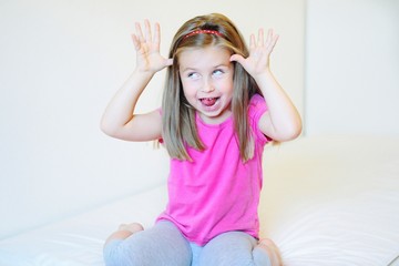 Adorable little girl making funny faces