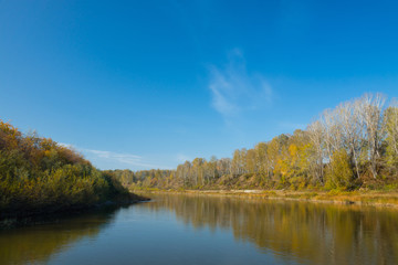 Autumn landscape with river and blue sky