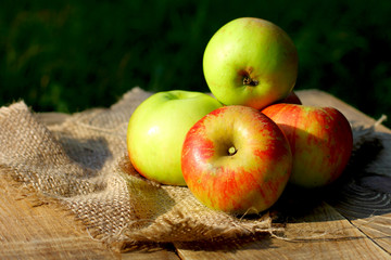 Sport still life image with natural organic apples on wooden background