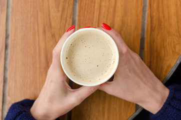 Young red woman with hot coffee