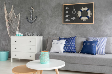Stylish grey living room with nautical decorations and trendy wall plaster