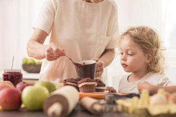 Young boy looking at  muffins