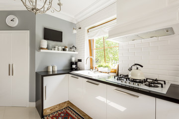 Open plan kitchen with white furniture