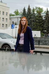 Young red woman walking in the city