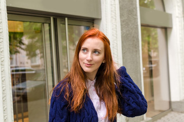 Fototapeta premium Young red woman walking in the city