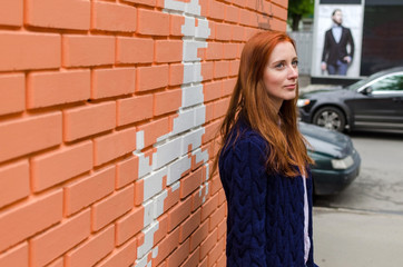 Young red woman walking in the city