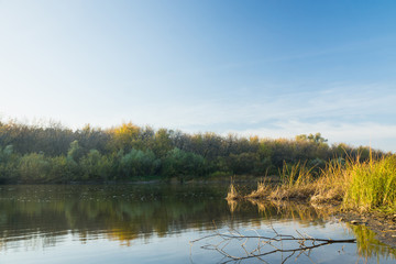 Autumn landscape with river and blue sky