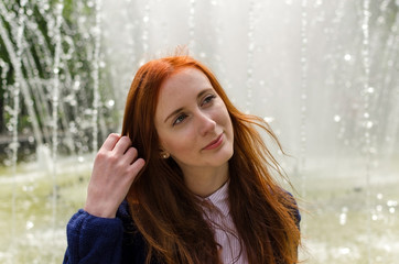 Young red woman walking in the city