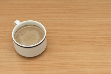 Hot coffee on wooden table.