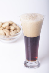 Black beer in the glass on the table