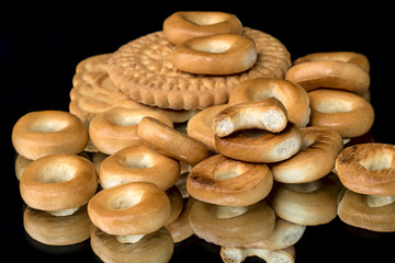 Cookies and small bagels on a black