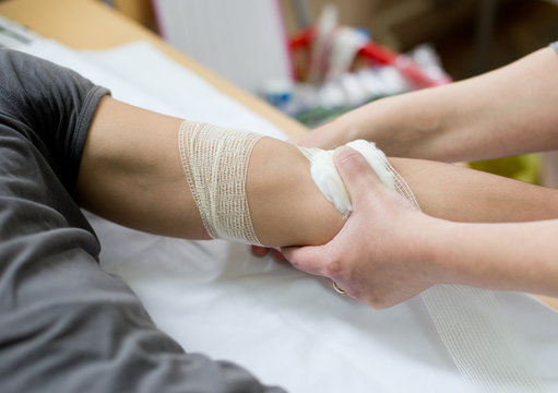Nurse bandaging hand