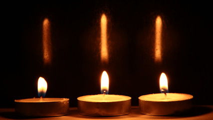 Burning candles on dark background