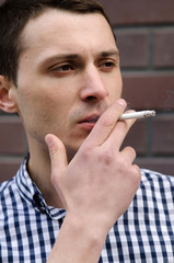 Young man smoking cigarette 
