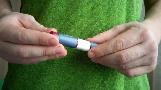 Diabetic man doing an insulin injection on belly