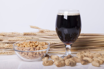 Black beer in the glass on the table