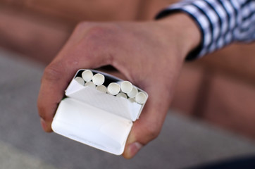 Young man smoking cigarette 