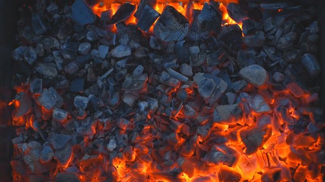 Coal burning in a brazier grill.