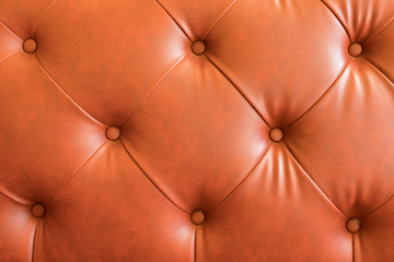 orange leather texture of sofa closeup shot - luxury classic leather texture - Vintage retro chair made 
