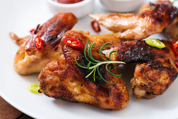 Baked chicken wings in the Asian style on plate.