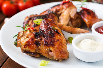 Baked chicken wings in the Asian style on plate.