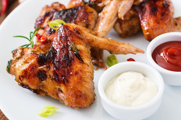 Baked chicken wings in the Asian style on plate.