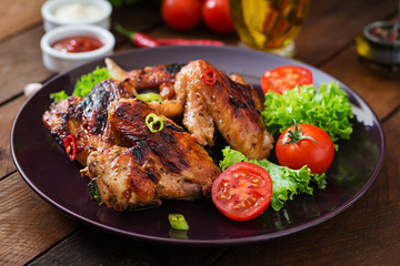 Baked chicken wings in the Asian style on plate.