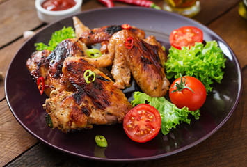 Baked chicken wings in the Asian style on plate.