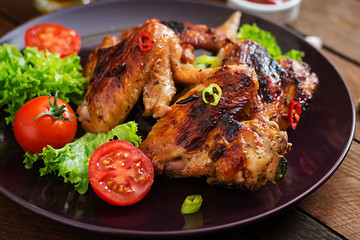 Baked chicken wings in the Asian style on plate.