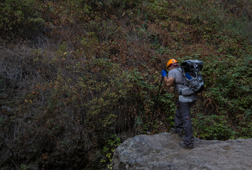 Backpacker man hiking in beautiful landscapes of Barranco del Infierno in Tenerife. Canary islands, Spain