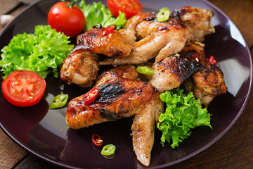 Baked chicken wings in the Asian style on plate.