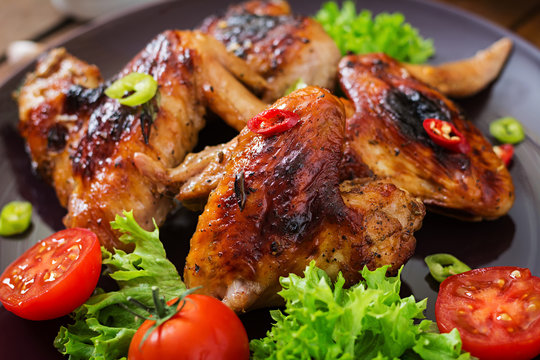 Baked chicken wings in the Asian style on plate.