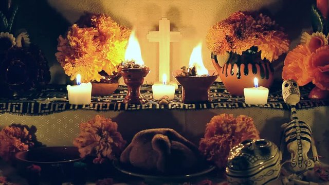 Day of the dead altar with cempasuchil flowers, burning copal and candles.