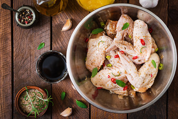 Raw marinated chicken wings prepared in Asian style with honey, garlic, soy sauce and herbs.Top view