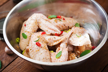Raw marinated chicken wings prepared in Asian style with honey, garlic, soy sauce and herbs