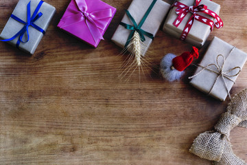 Handmade christmas decoration and gift boxes on wooden table. Top view and copy space.