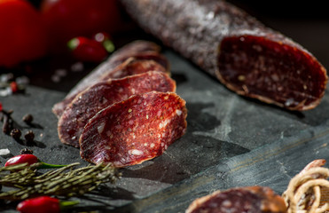 thin sliced sausage jerked on a stone background