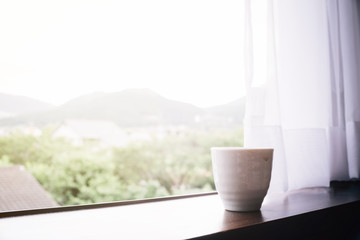 Japanses cup of tea at window with mountain view at yufuin japan