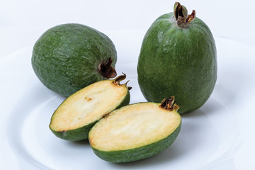 Ripe feijoa on white plate