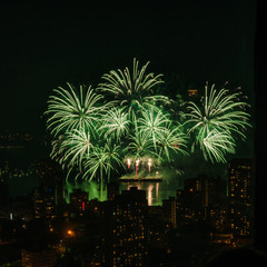 Naklejka premium Fireworks over beautiful night city view in Vancouver, Canada.
