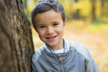 Six years old child autumn season in a park