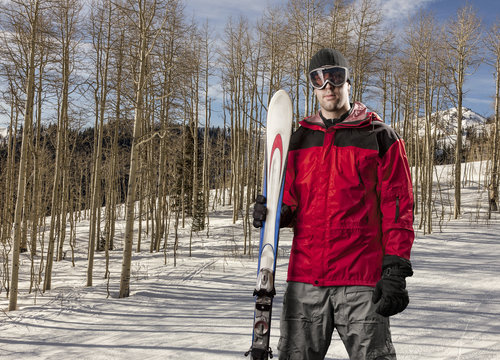 Skier holding a pair of skis