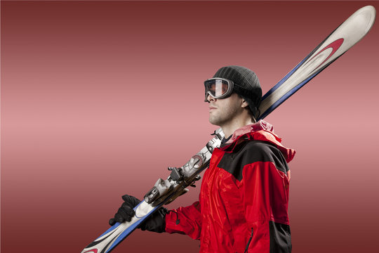 Skier holding a pair of skis