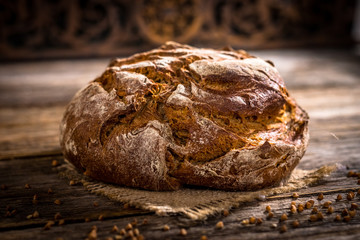 Freshly baked  bread on rustic wooden background