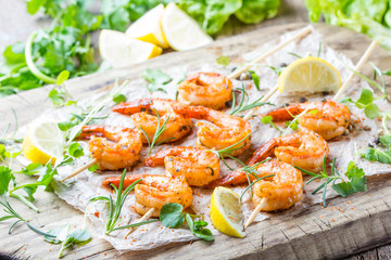 Grilled fried Shrimps Prawns on wooden skewers with spices