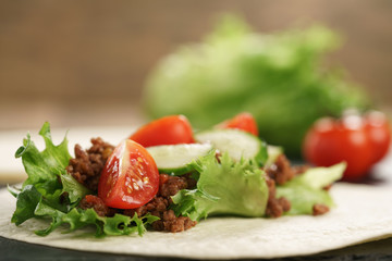 open tortilla with beef, frillice and vegetables